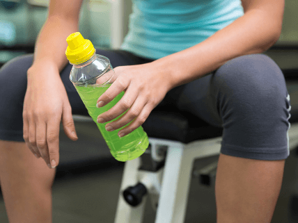 What makes for a good hydration stick packet formula shown with a fitness enthusiast holding a green sports drink.